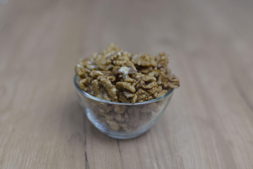Bowl of unshelled walnuts, a nutritious nut with brain and heart benefits.