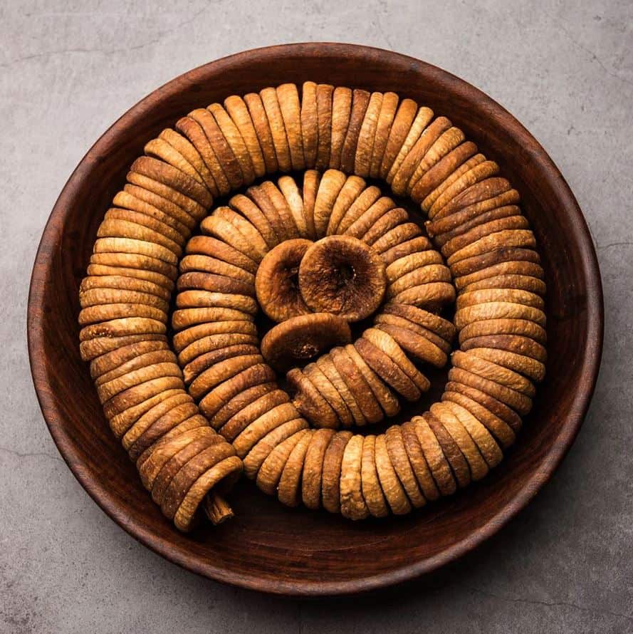 Dried medicinal herbs spiraled in a wooden bowl for traditional herbal remedies, emphasizing natural healing from Abbasi Herbal Corner.